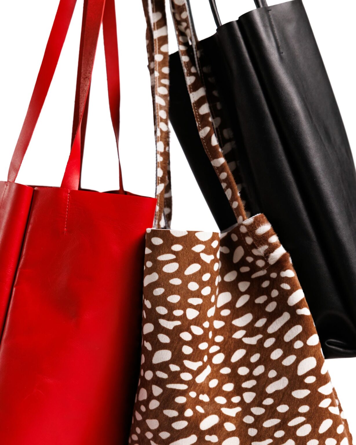 Handmade leather tote bags in red, black and spotted calf hair